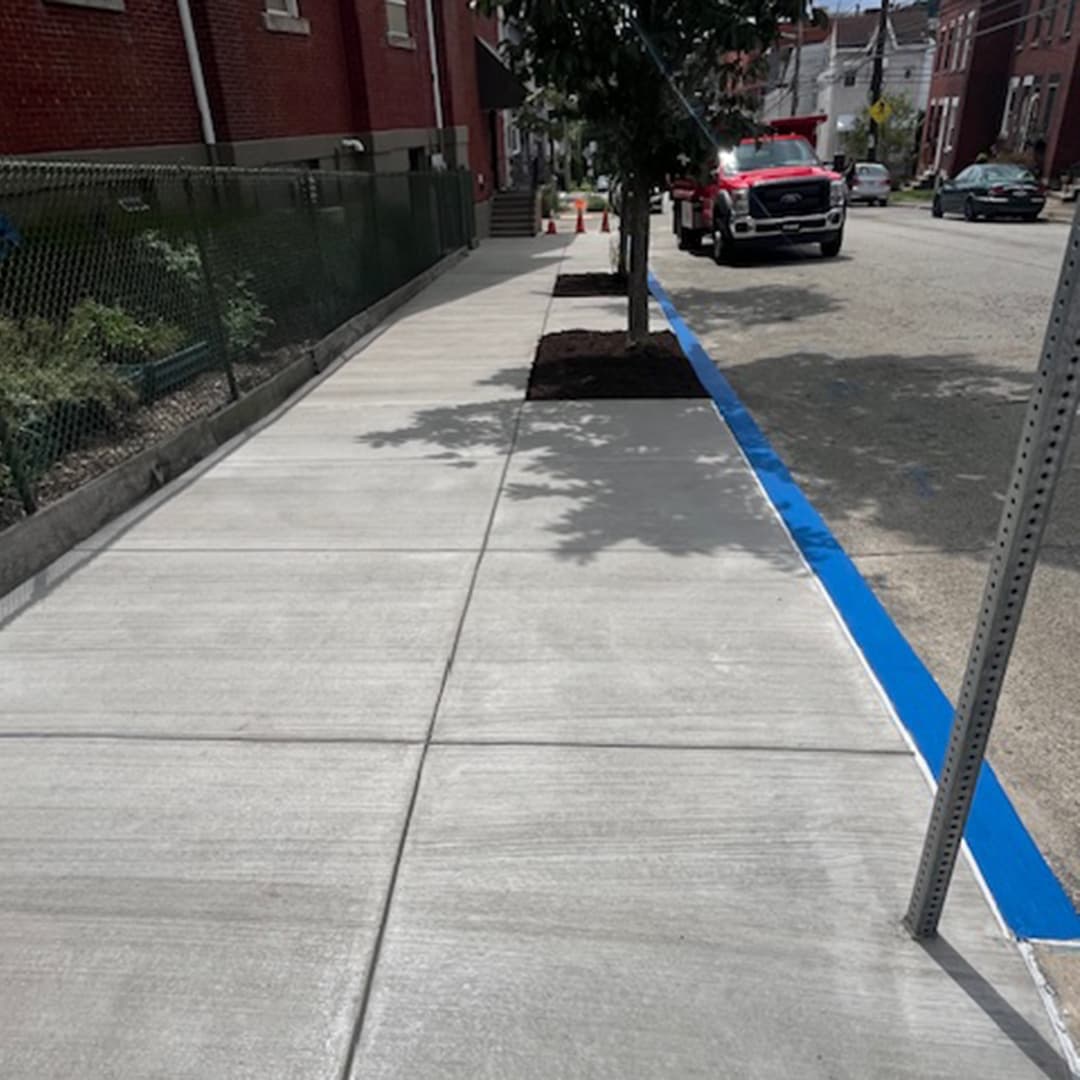 Newly constructed concrete sun deck with decorative stone retaining walls