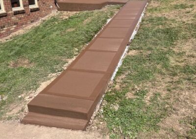 concrete walkway path installed and dyed brown by Angelo Mancuso LLC.